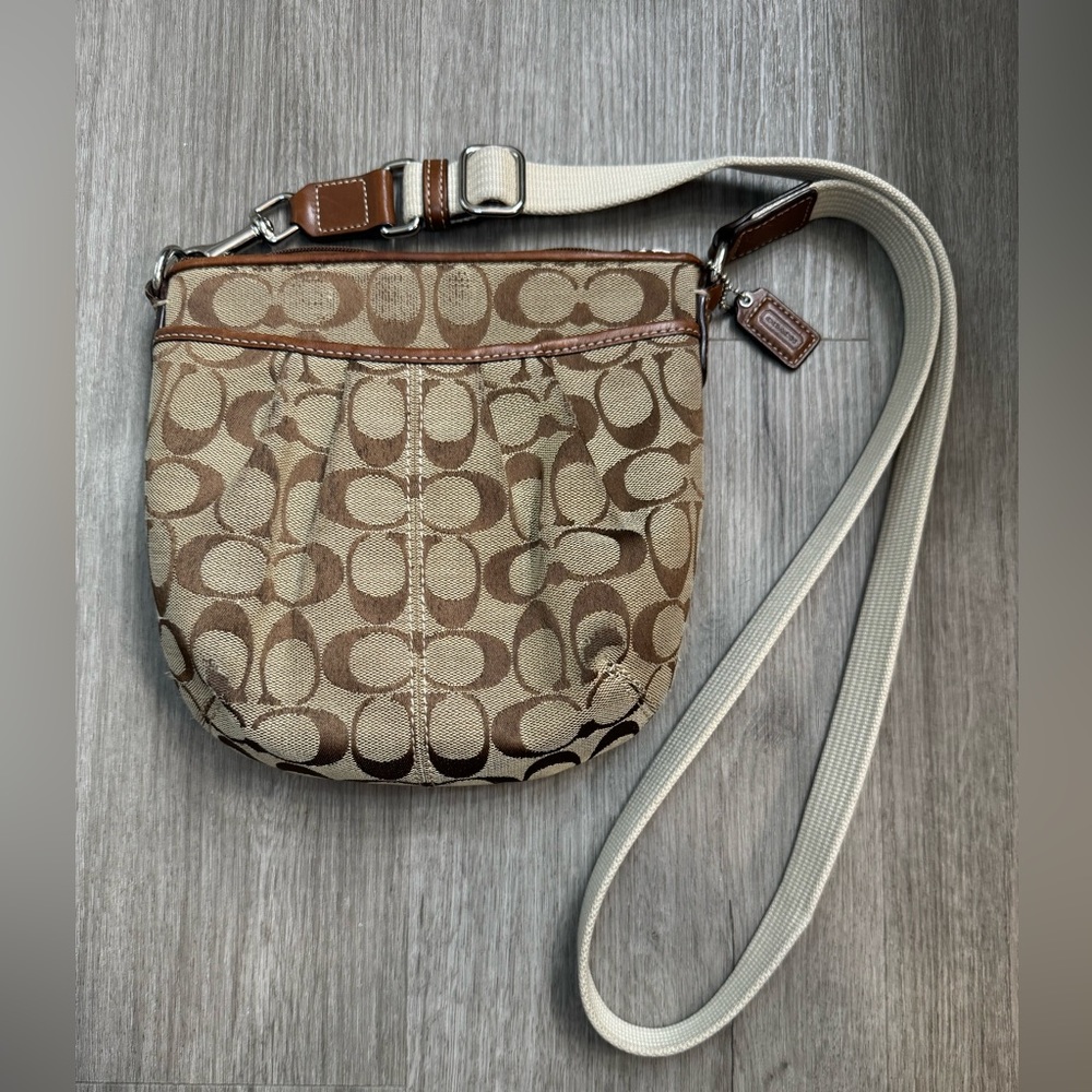 Signature Coach crossbody bag (H: 7”x L: 8”x W: 2”) Tan/Brown.